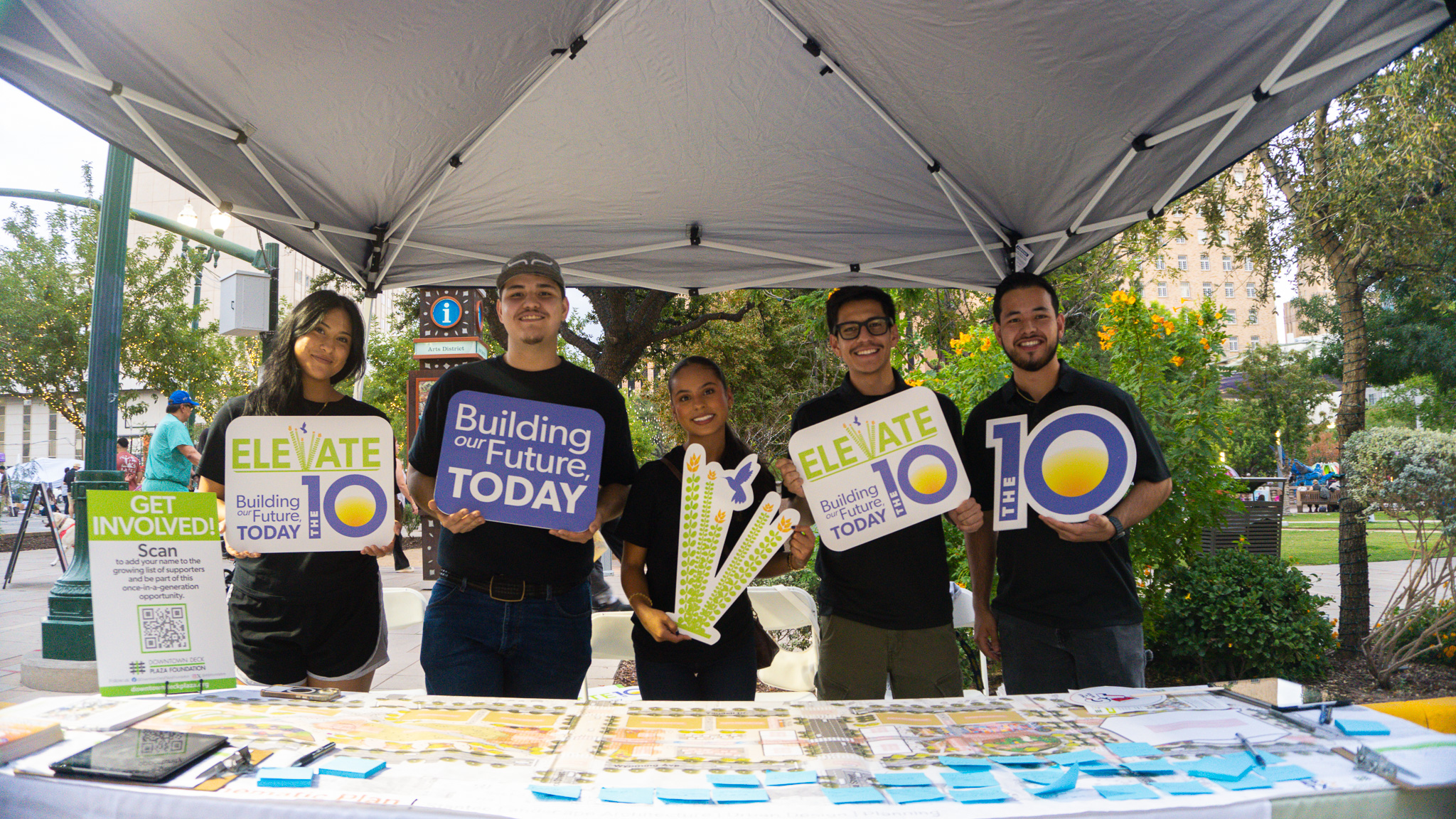 Alliance at Chalk the Block Pop-up Event, behind activation table showing a schematic map of the proposed Downtown Deck Plaza